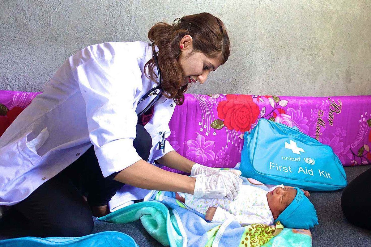 This Syrian refugee and UNICEF volunteer conducts a neo-natal check-up. 