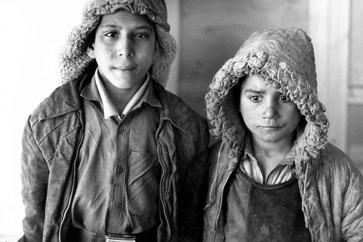 Two boys dressed for the cold winter attend a "drop-in" centre in Kabul in 1992. 