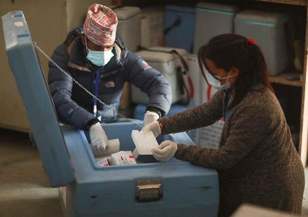 Officials at the district vaccine store room in Jumla District in Nepal's remote far west unpack the COVID-19 vaccines.