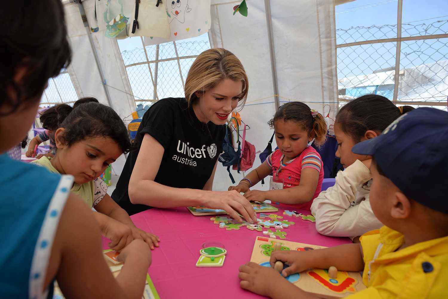 Tara Moss playing with children
