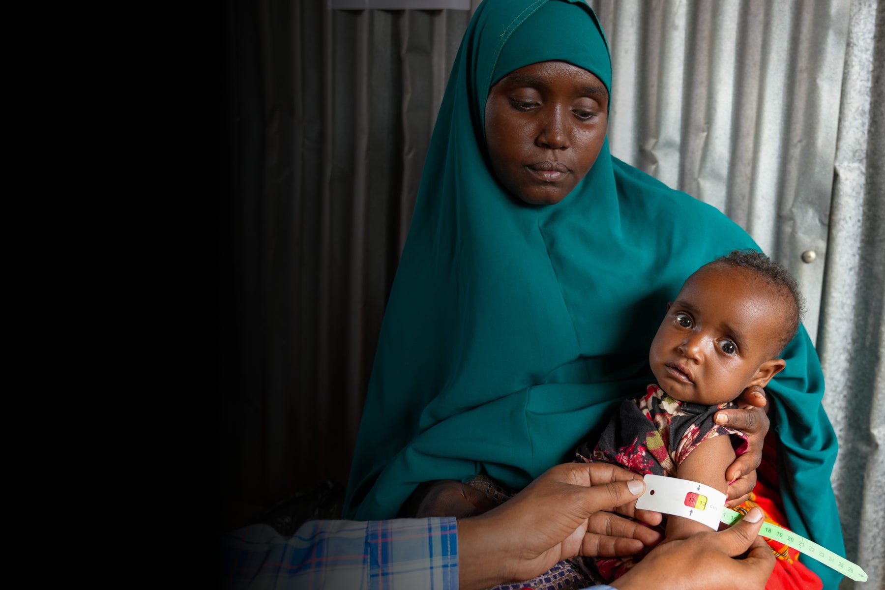 Mother holding her child in Somalia who is suffering from malnutrition
