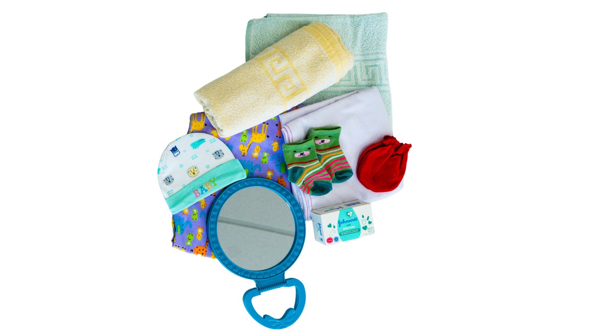 A flatlay of kangaroo care items including a beanie, socks and a rattle. 