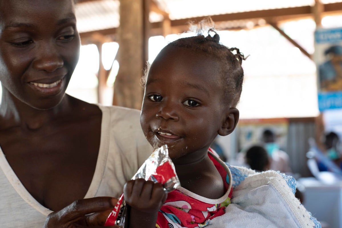 Jenty is held by her mother at a nutrition centre in Yambio South Sudan