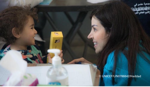 Five-year-old Huda holds up a box of nutrition supplements supplied by a UNICEF-supported mobile clinic. 