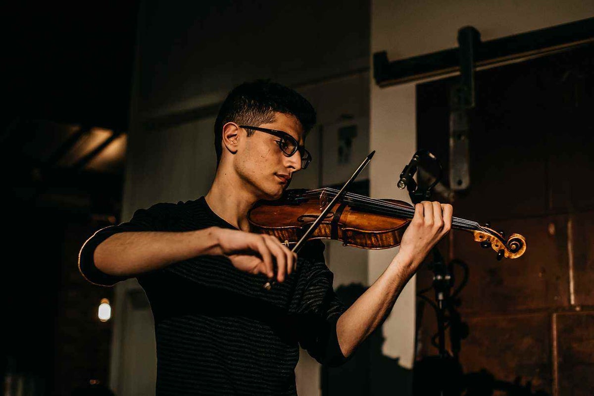 Aboud playing violin at the Cook For Syria dinner held at Nomad in Surry Hills, Sydney.