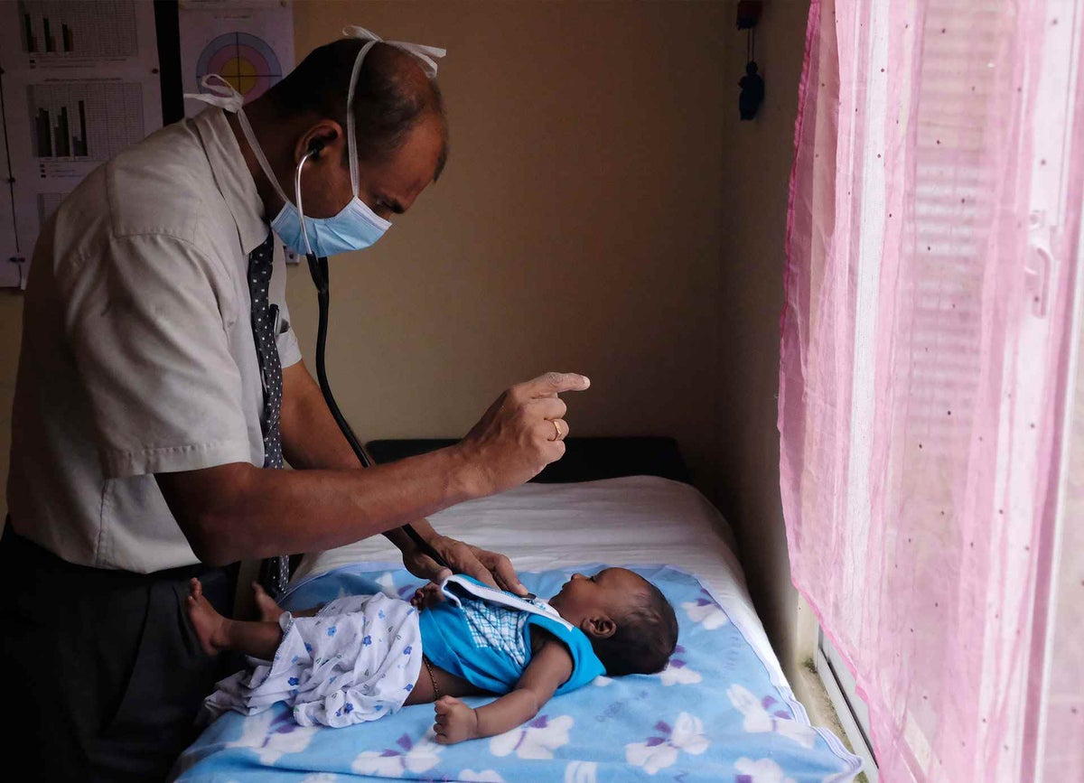 Dr. Ruwan conducts a health checkup at a health clinic in Sri Lanka. 