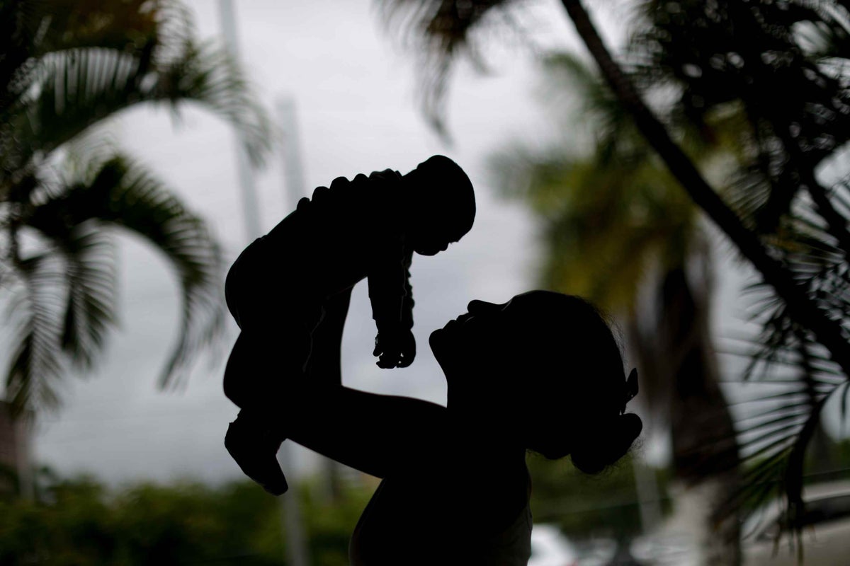 Alice*, 15, holds her baby in Recife, Brazil. He was born with microcephaly, a condition where babies are born with smaller than normal head size and underdeveloped brains
