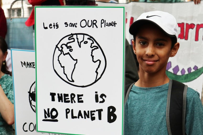 Boy with sign on climate change