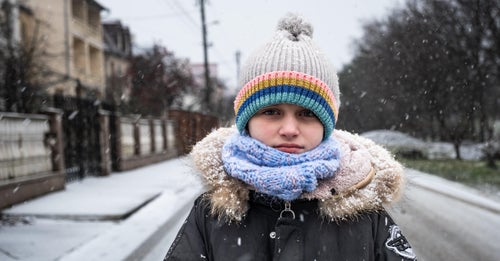 Ukraine child standing in the snowy streets