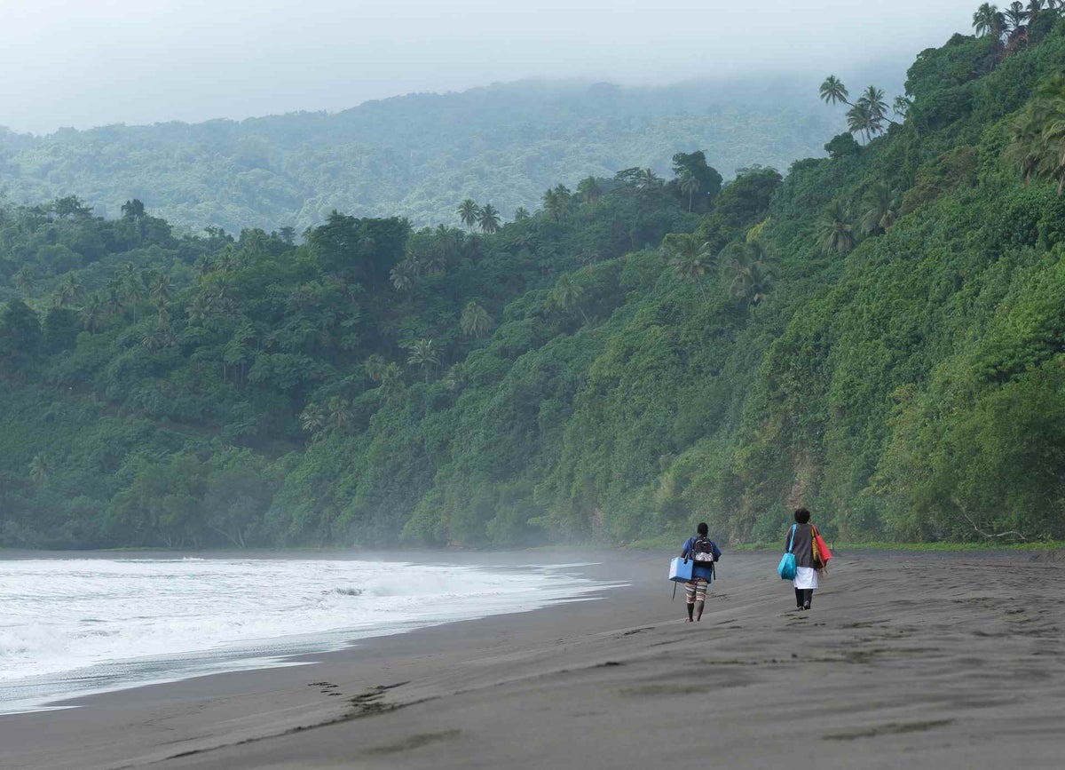 Midwife Rosalinda and her assistant hike the coastline to deliver vaccines on Epi Island, Vanuatu. 