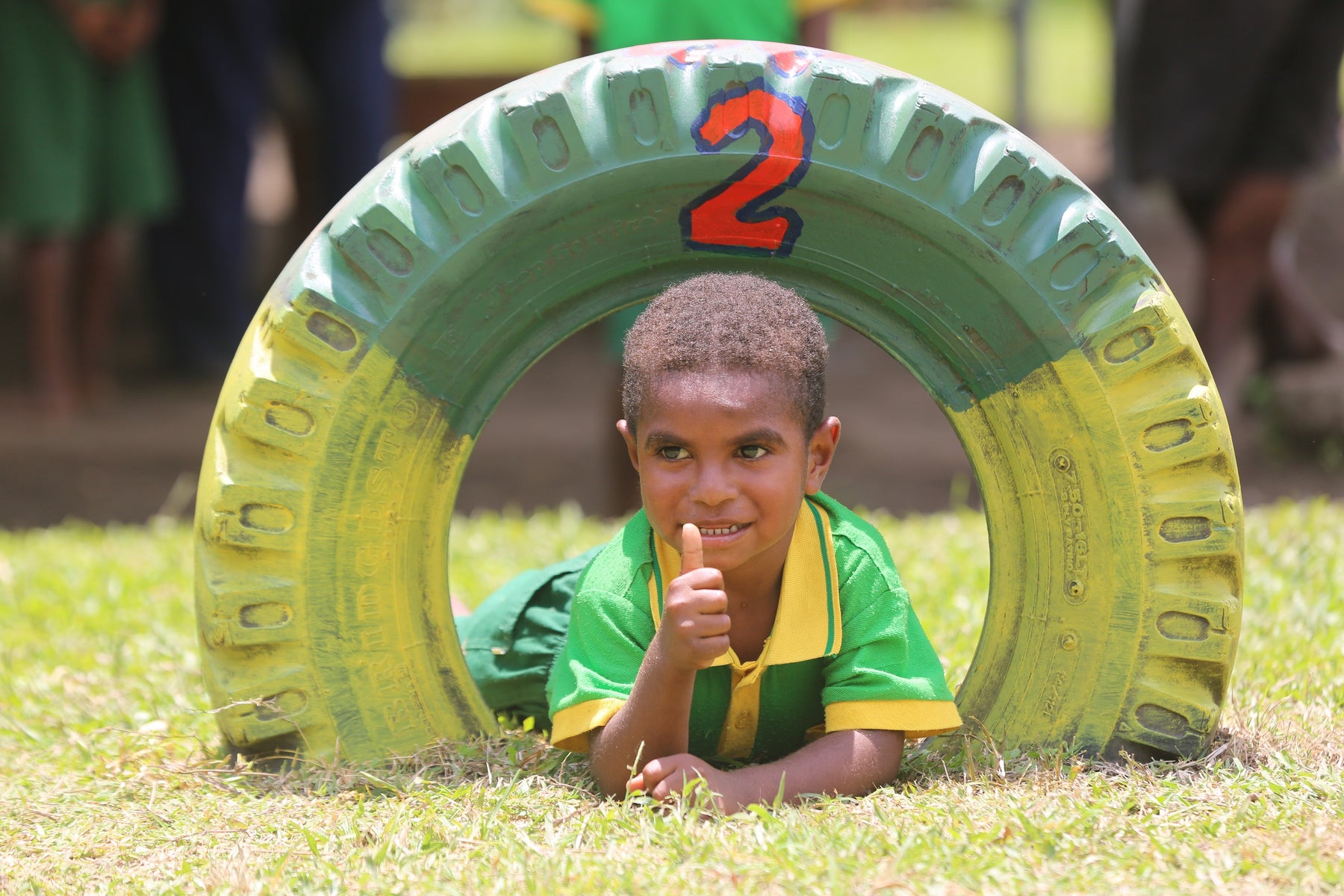 Young boy lays inside a tyre toy