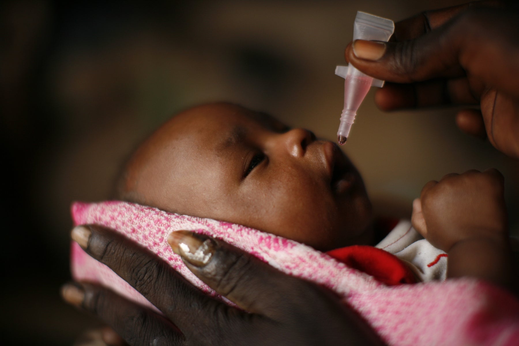 Baby receiving oral polio vaccination