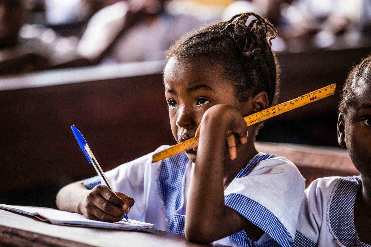 A young girl listens carefully during class in Kinshasa, Democratic Republic of Congo, October 2018