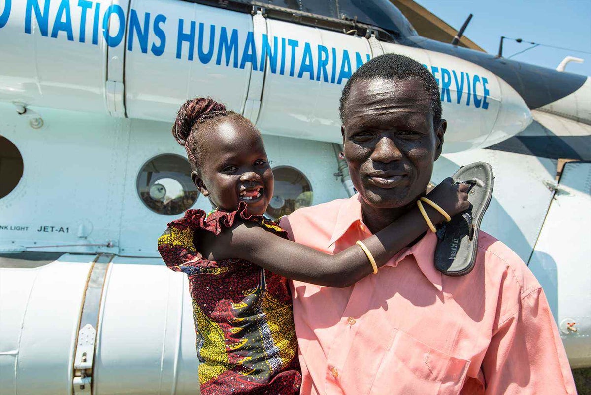 Father holds daughter after being reunited