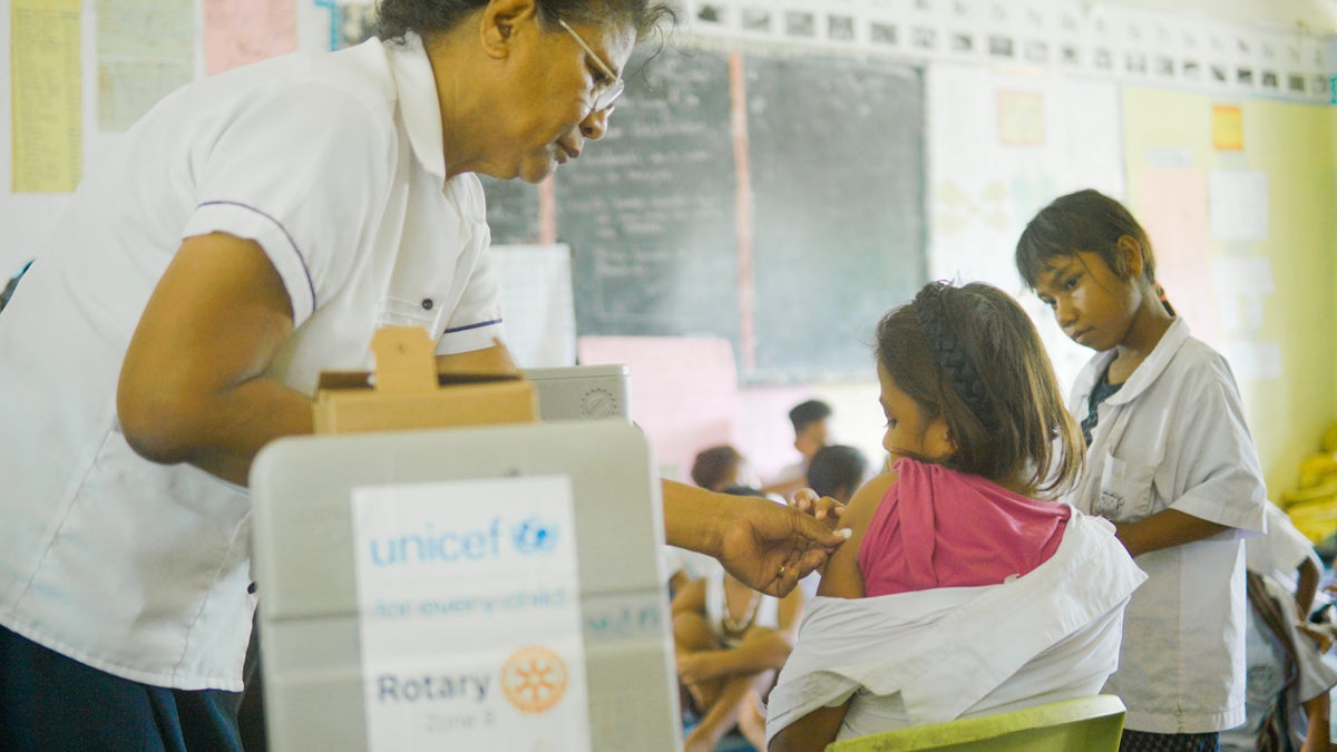Katarina administers the HPV vaccine on a girl in Kiribati.