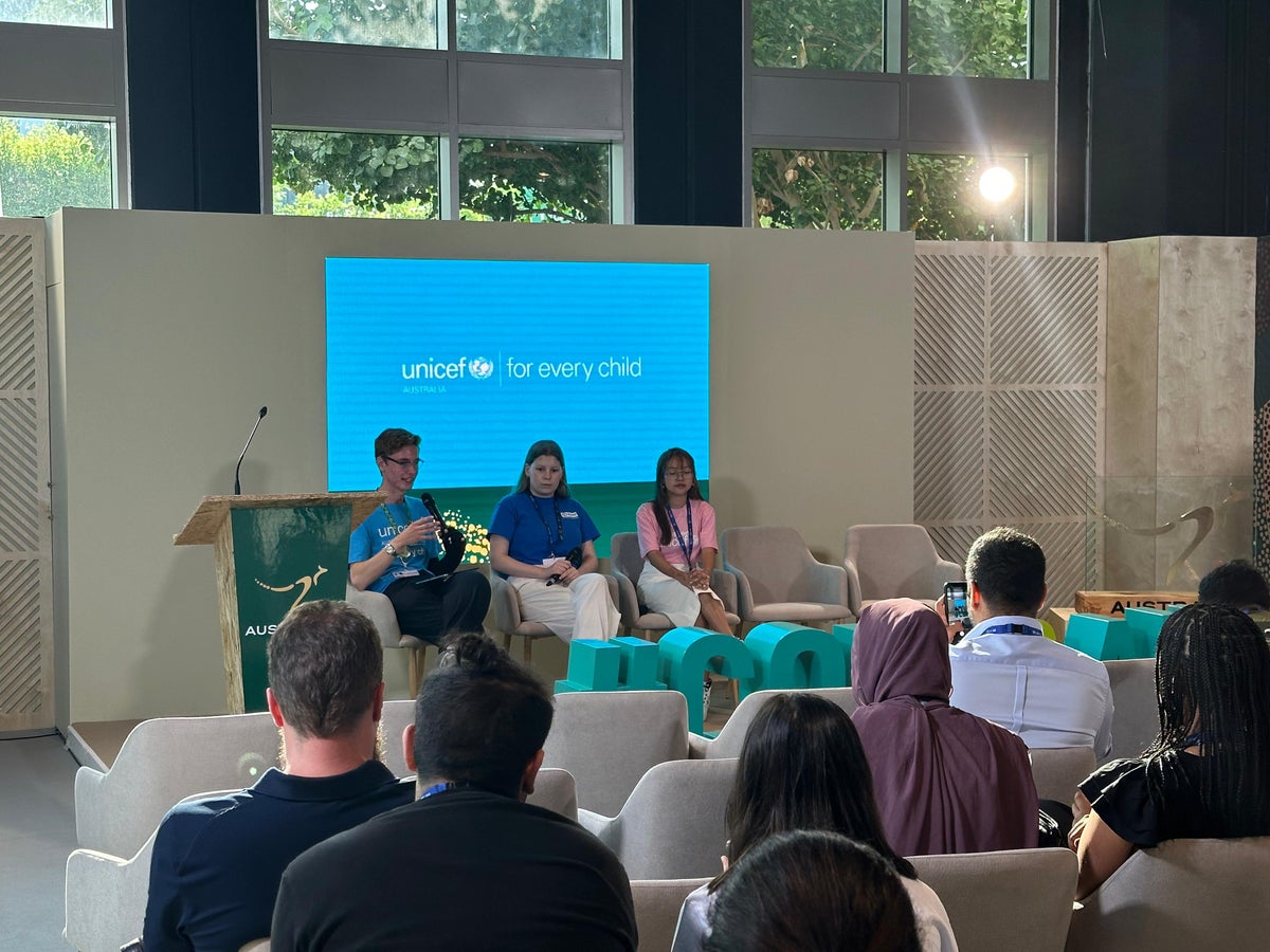 Three people speak at a UNICEF panel at COP28 in Dubai, United Arab Emirates