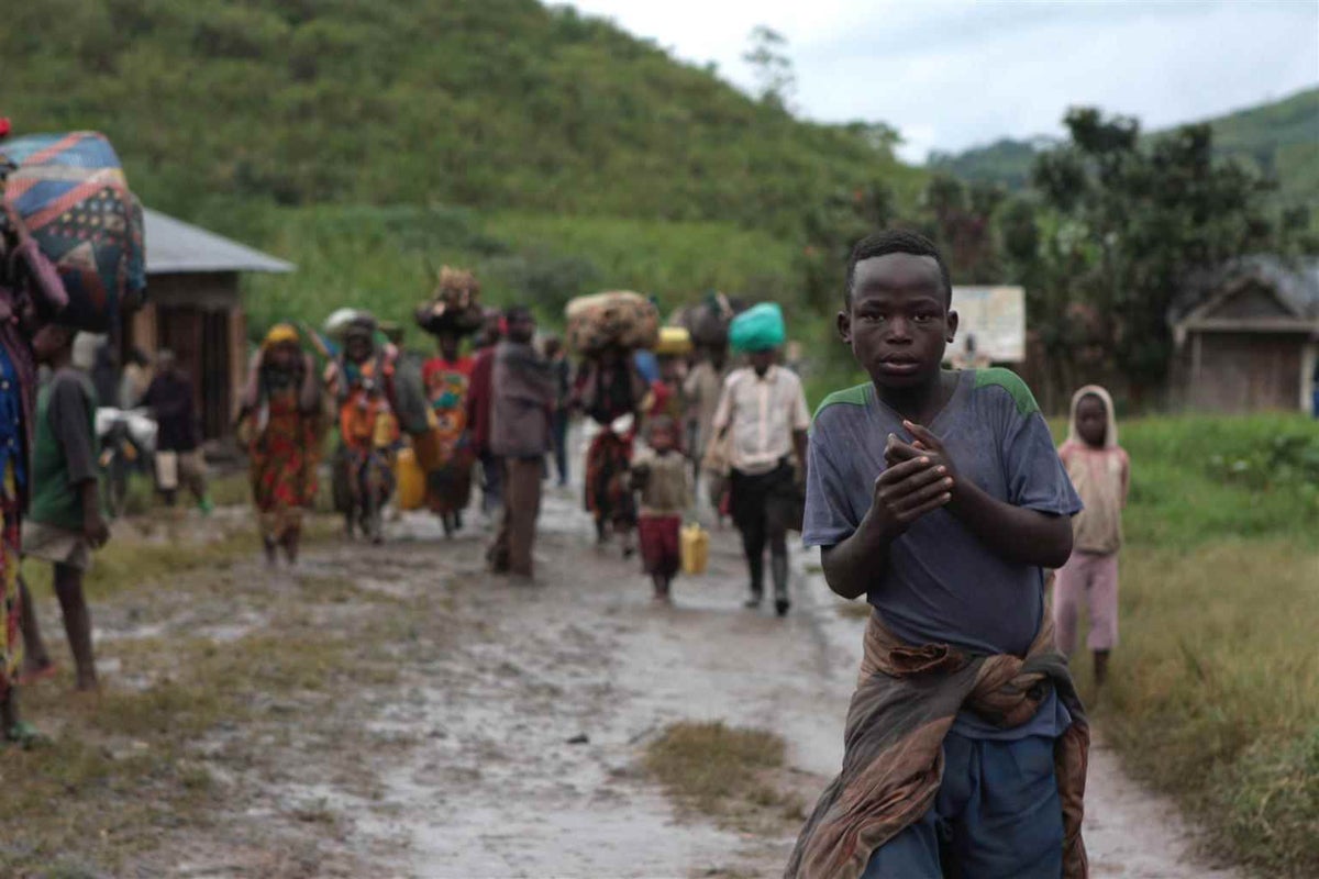 Displaced people enter the town of Kalembe, in North Kivu Province in the Democratic Republic of the Congo after fleeing their homes in the nearby town of Piti