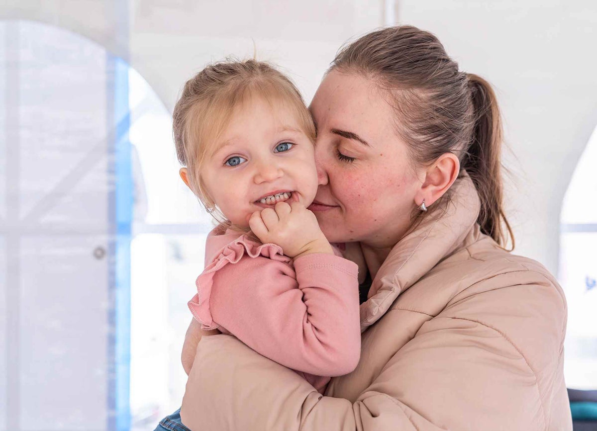Two-year-old Emilia is reunited with her mother Maryna at a UNICEF-supported Blue Dot hub in Romania. 