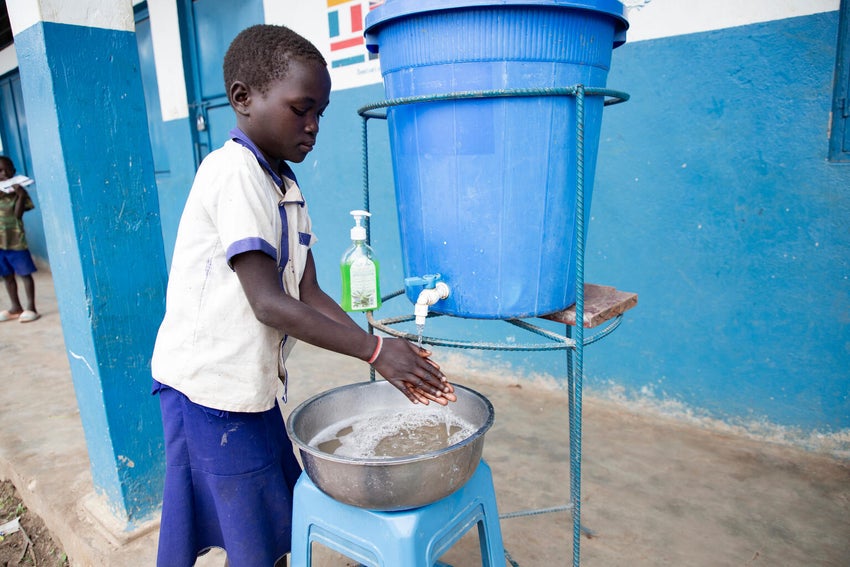 Eight-year-old Lemita washes her hands at the UNICEF-supported primary school in the DRC.