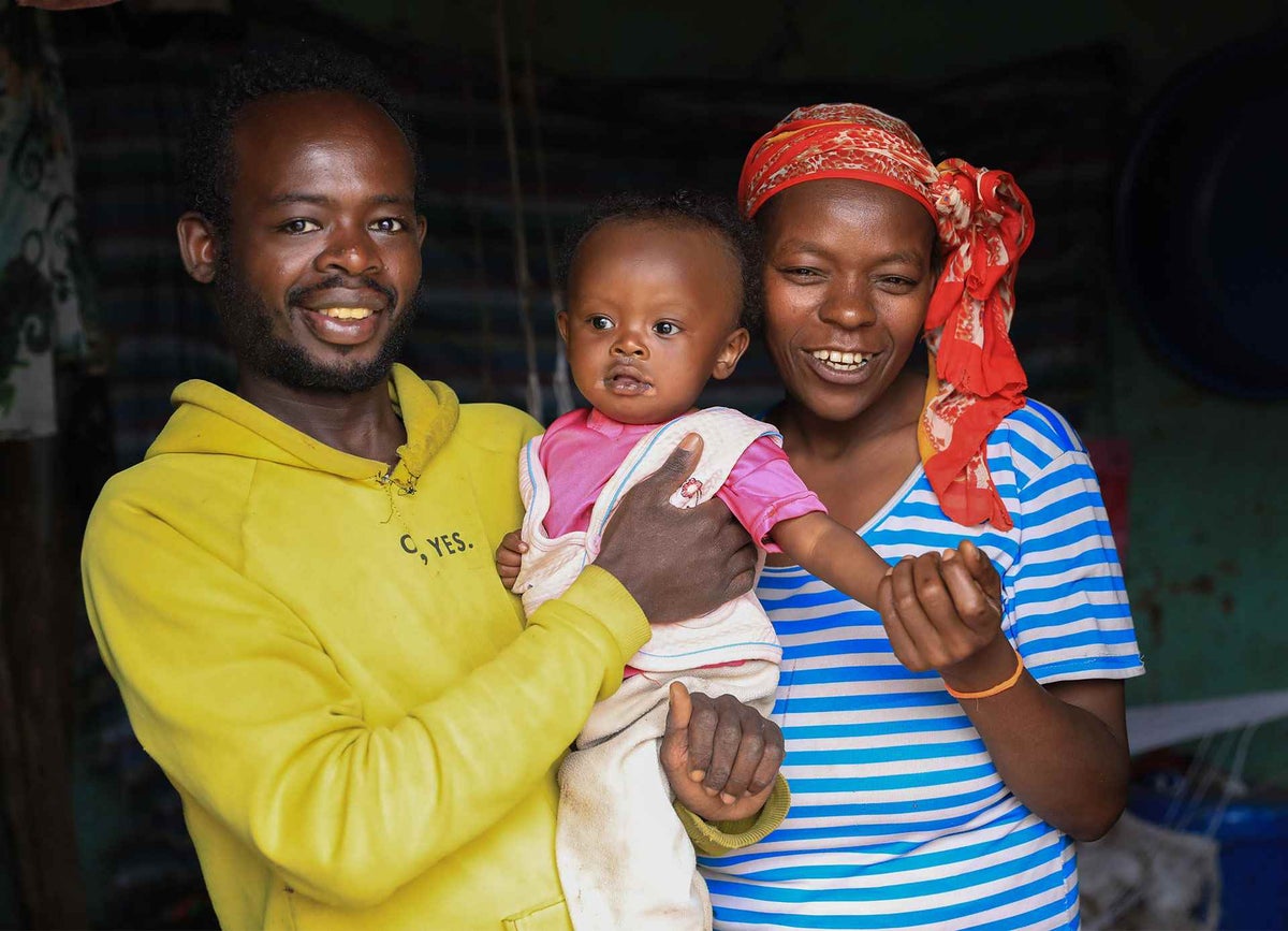 One-year-old Mekdes at home with her parents after returning from the hospital for treatment for measles.