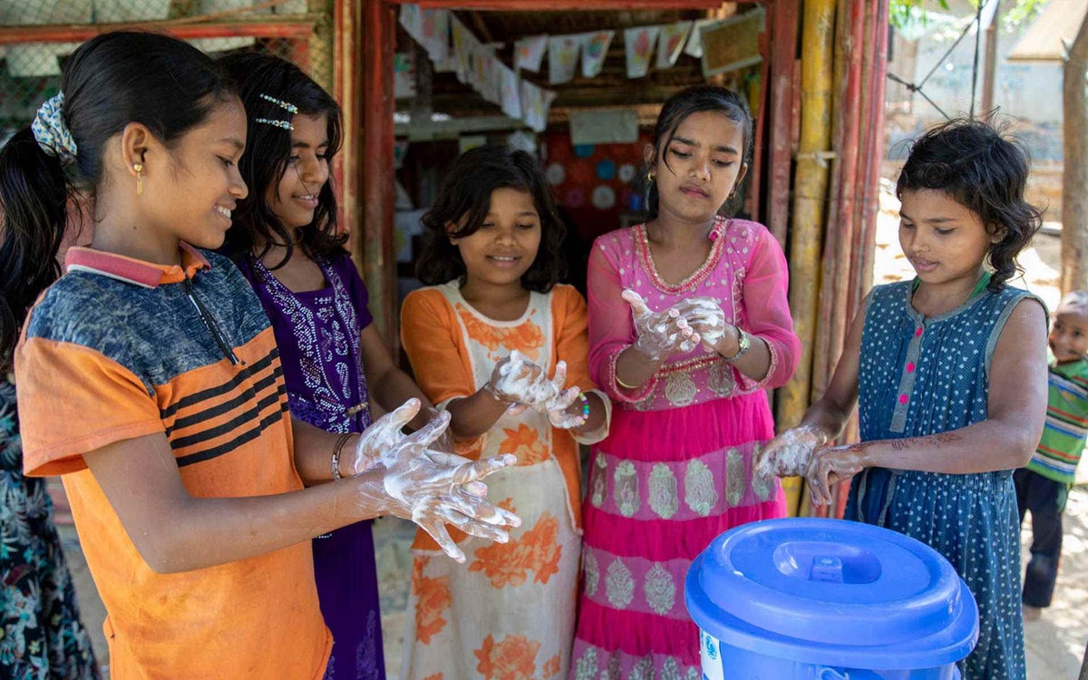 Children wash their hands with soap as part of a UNICEF-supported program to prevent coronavirus in the Rohingya refugee camps.