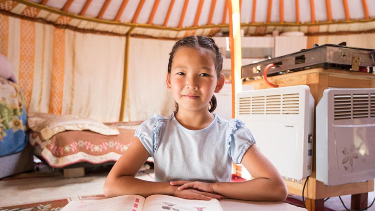 A Mongolian child living in her insulated Ger dwelling