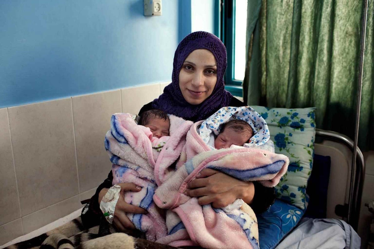 Islam Selek with her newborn twin babies in Palestine in 2014. 