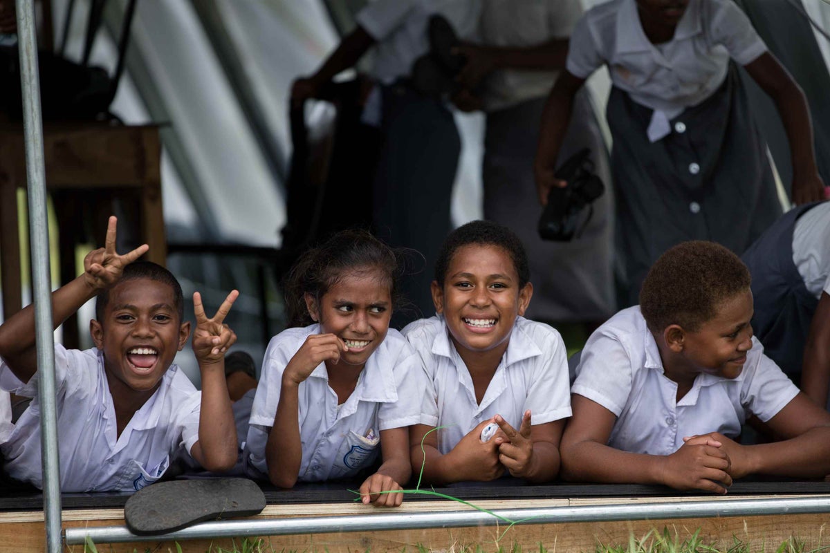 Children looking out the window of their classroom in Fiji