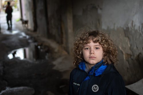 A young boy looking at the camera