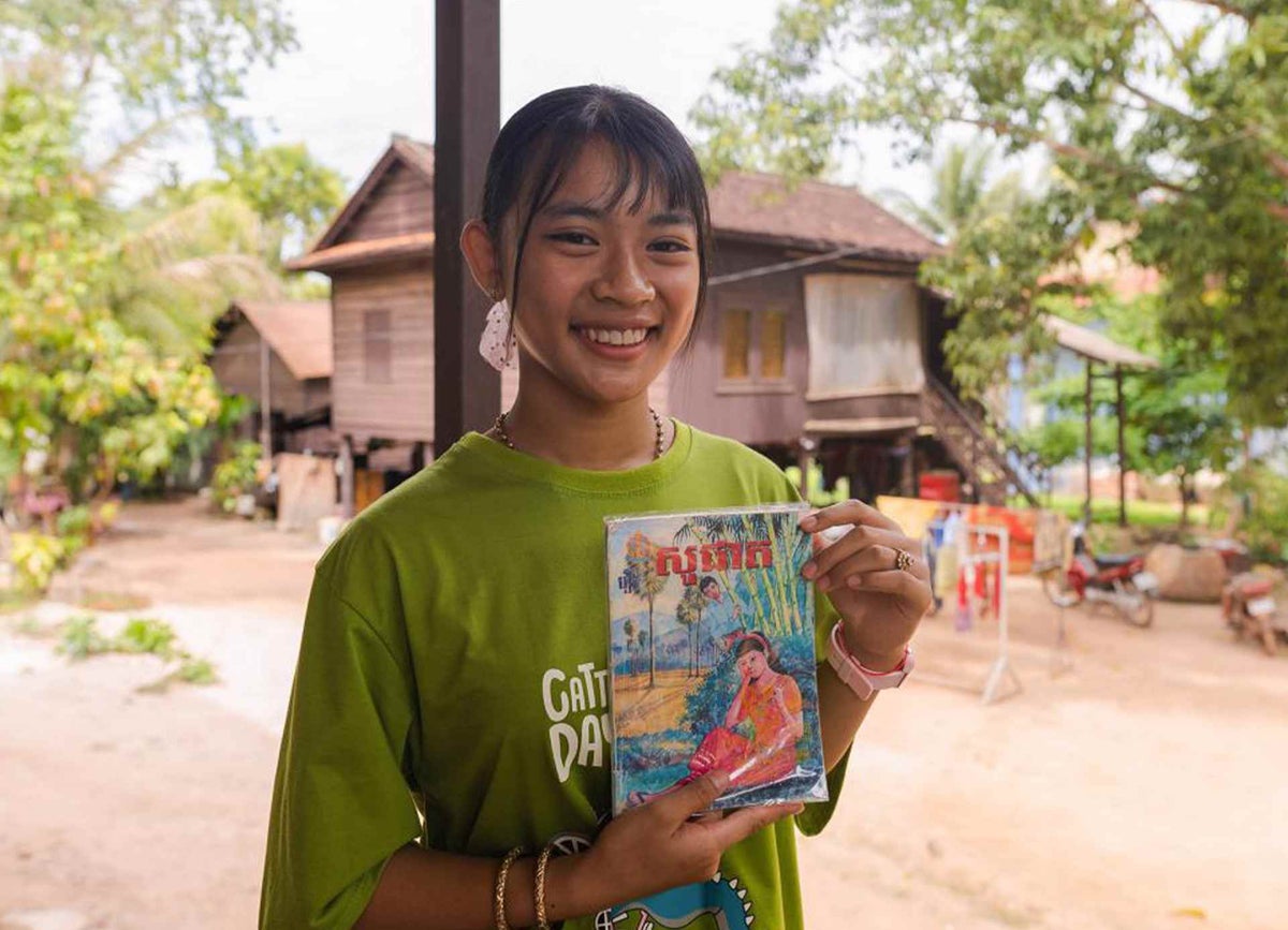 Nearadey helped to distribute lesson printouts at her school in Siem Reap