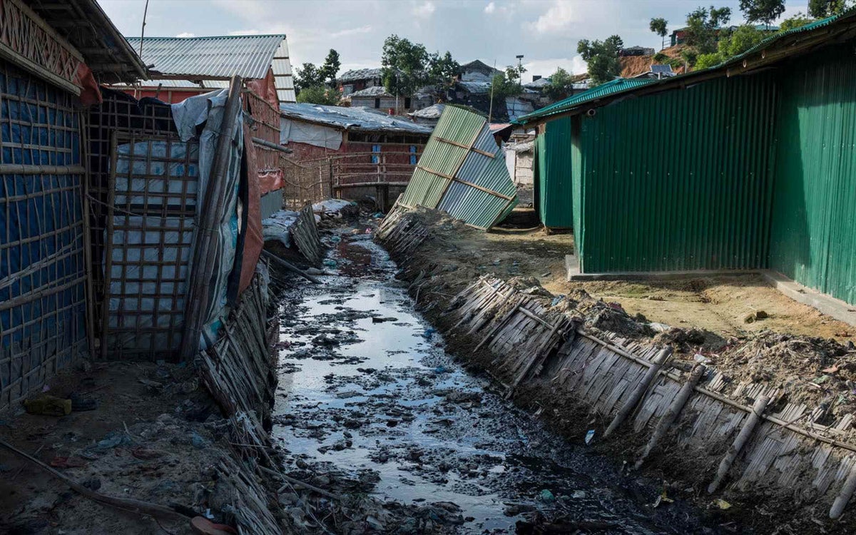 drainage channel cuts through the Kutupalong refugee camp in Cox’s Bazar. Due to high congestion and poor living conditions, the risk of disease transmission has always been high in the camps