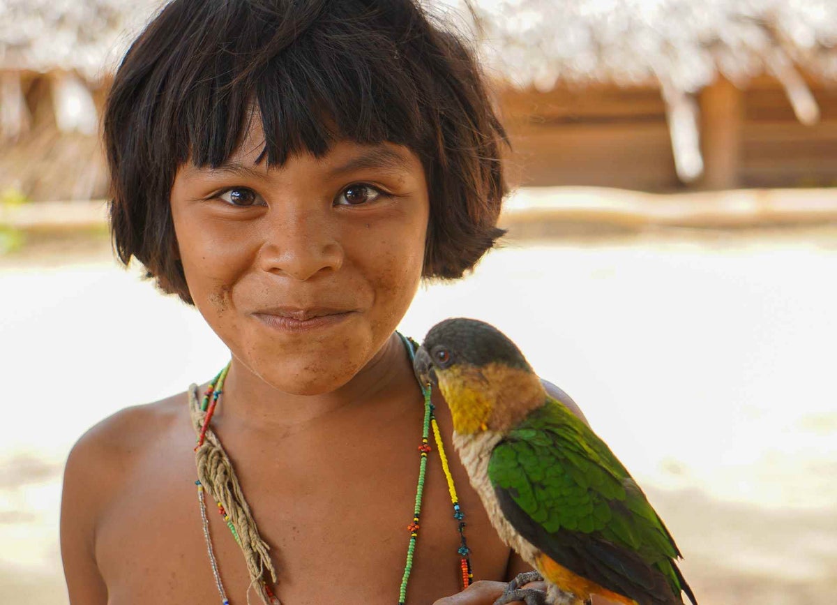 Fidelina, 12, from the Hoti ethnic group, smiles at the camera.