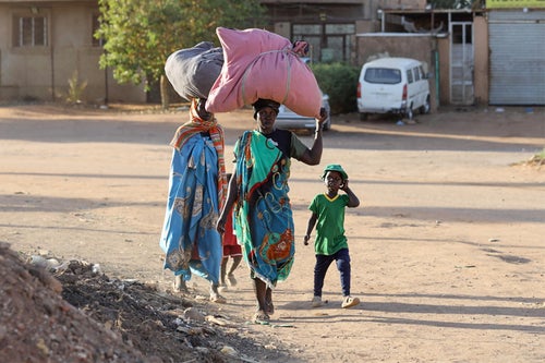 People fleeing their neighbourhoods amid fighting in Sudan. 