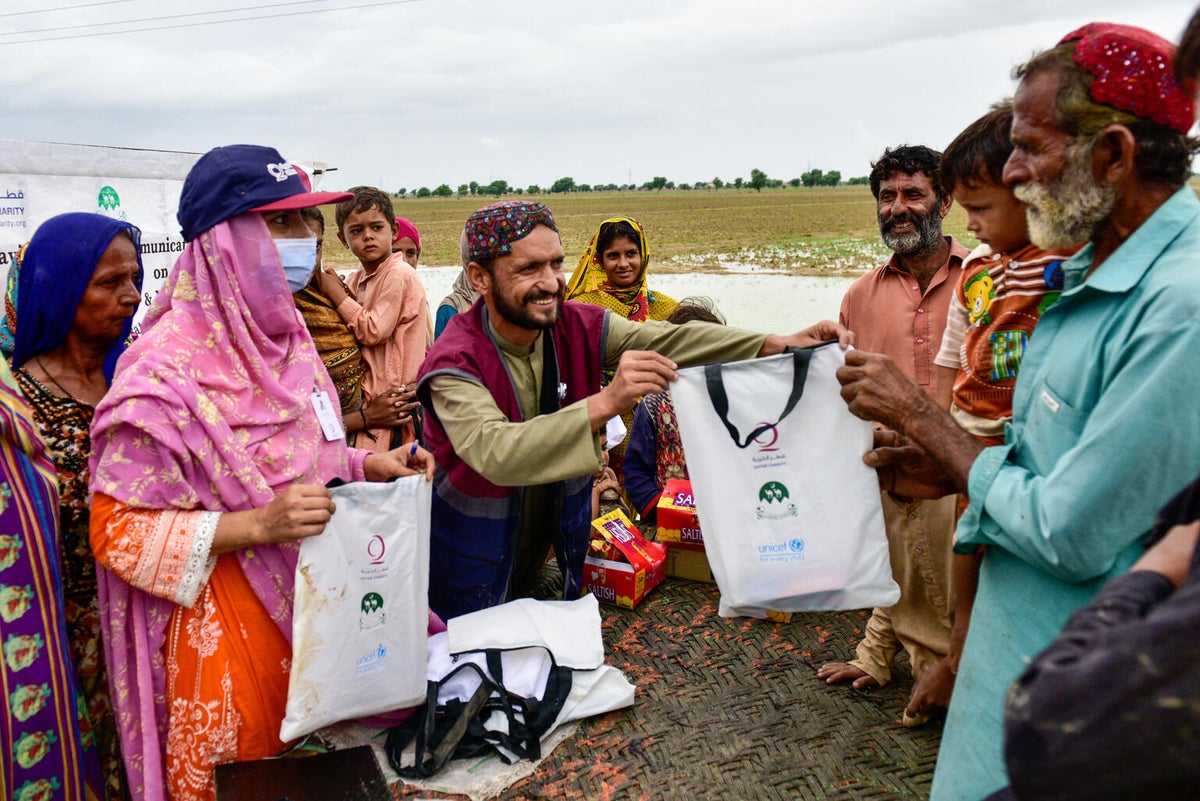 A group of people receiving bags with emergency supplies