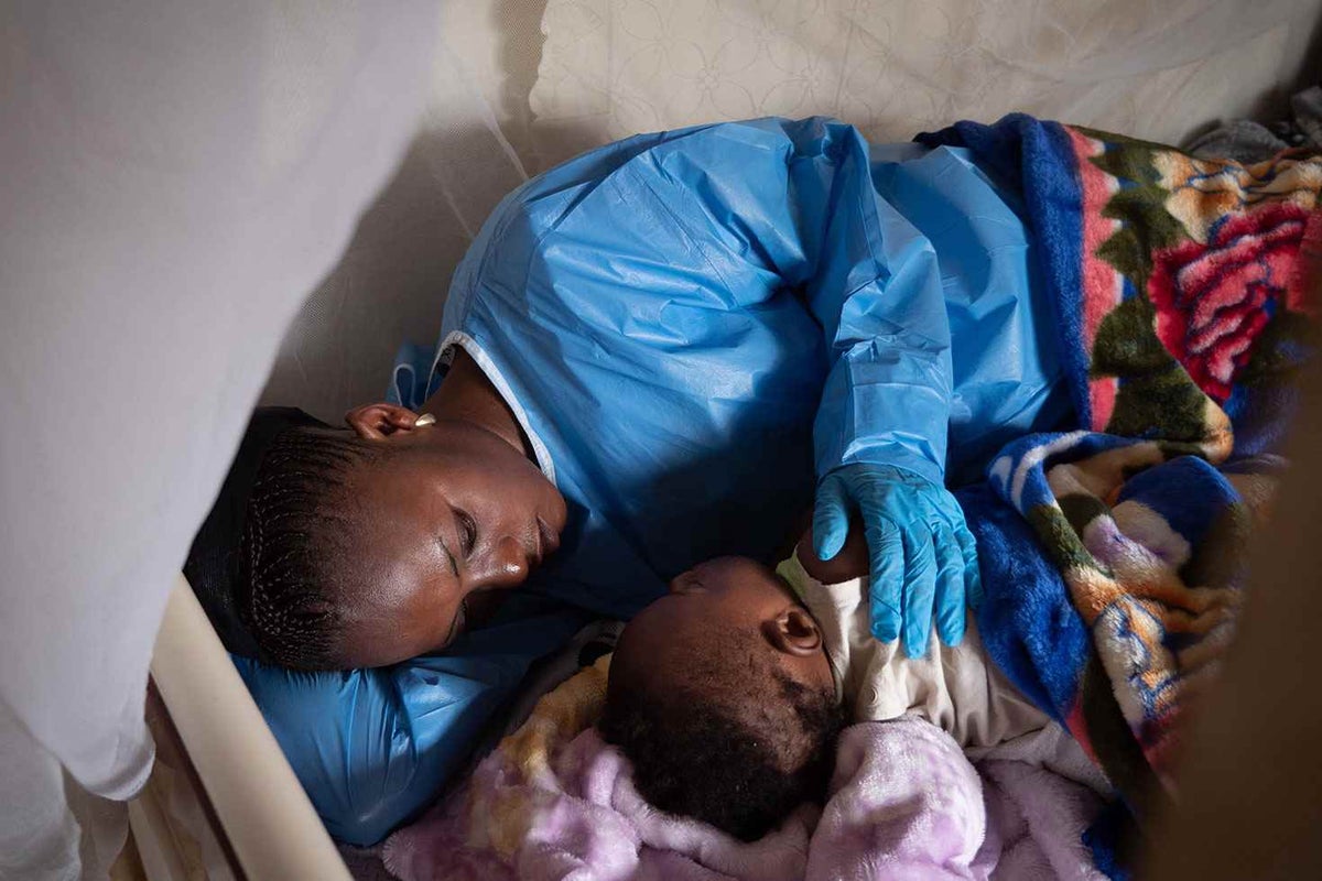Ebola survivor Kavira feeds, plays, and bathes children like six-month-old Josue, whose mother died from Ebola and whose father is still undergoing treatment.