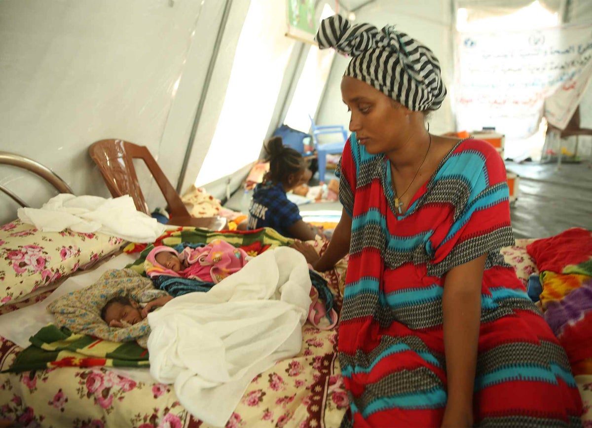 A woman looks at her babies.