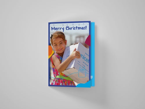 Christmas card showing girl with UNICEF gift box