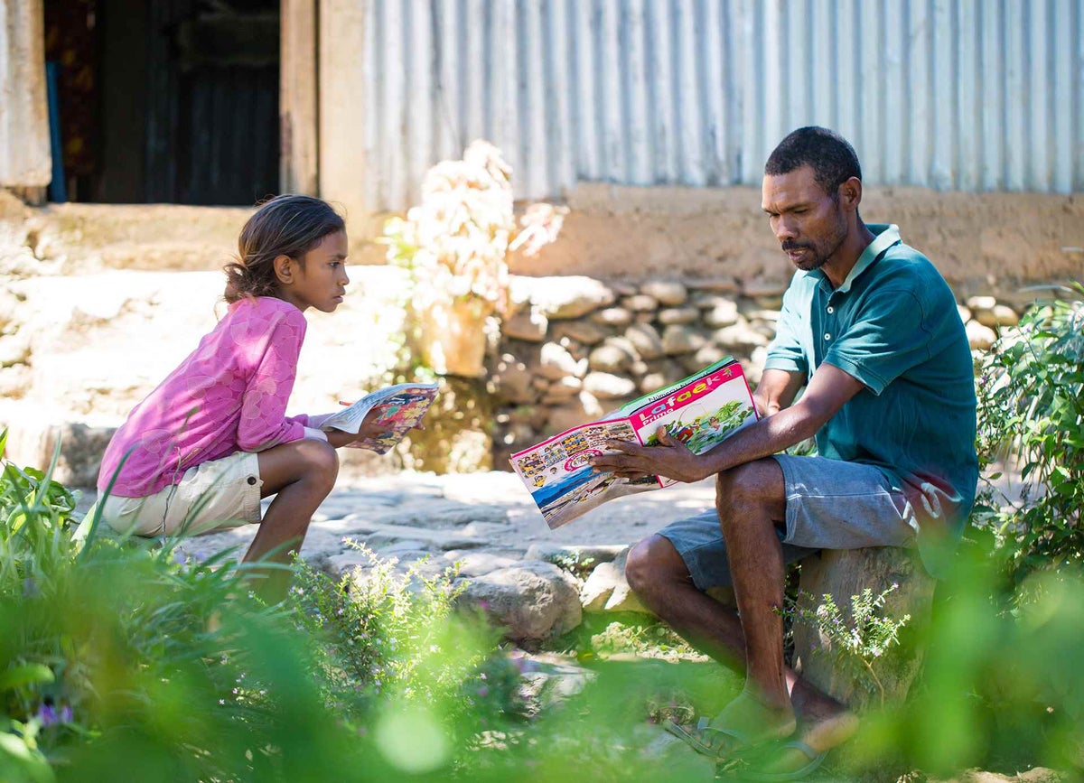 Father helps daughter with her school work