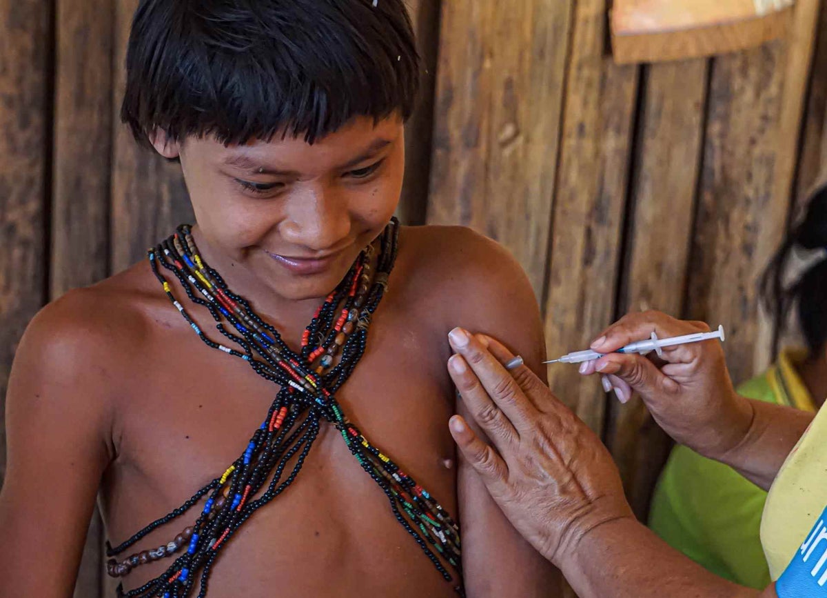 A child from the Hoti ethnic group receives immunization at a rural outpatient group in Venezuela.