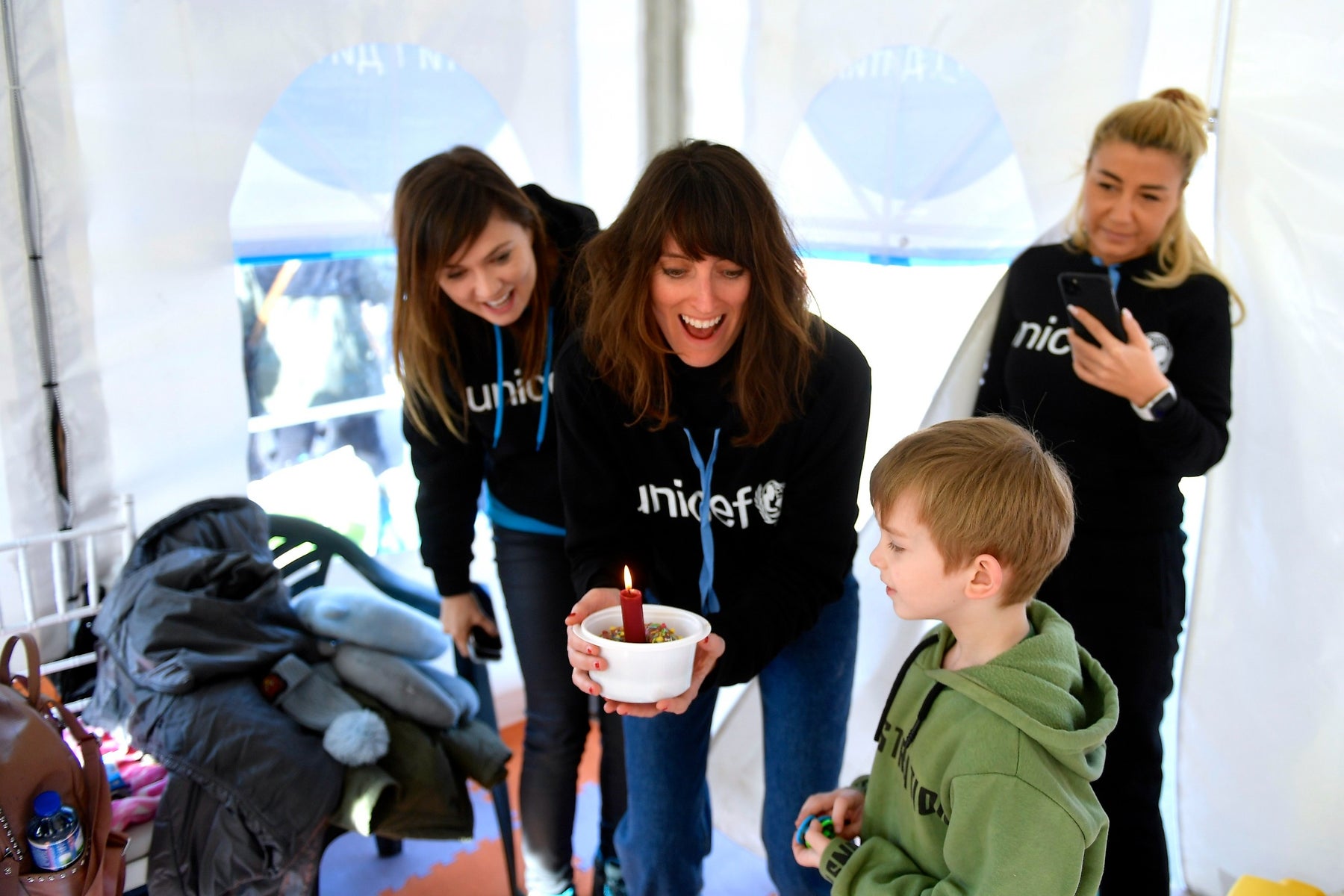 UNICEF workers with child for his birthday