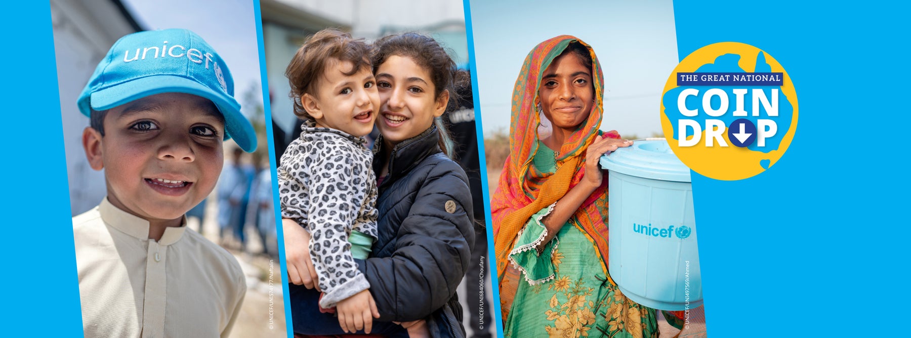 A smiling girl holding her young brother.
