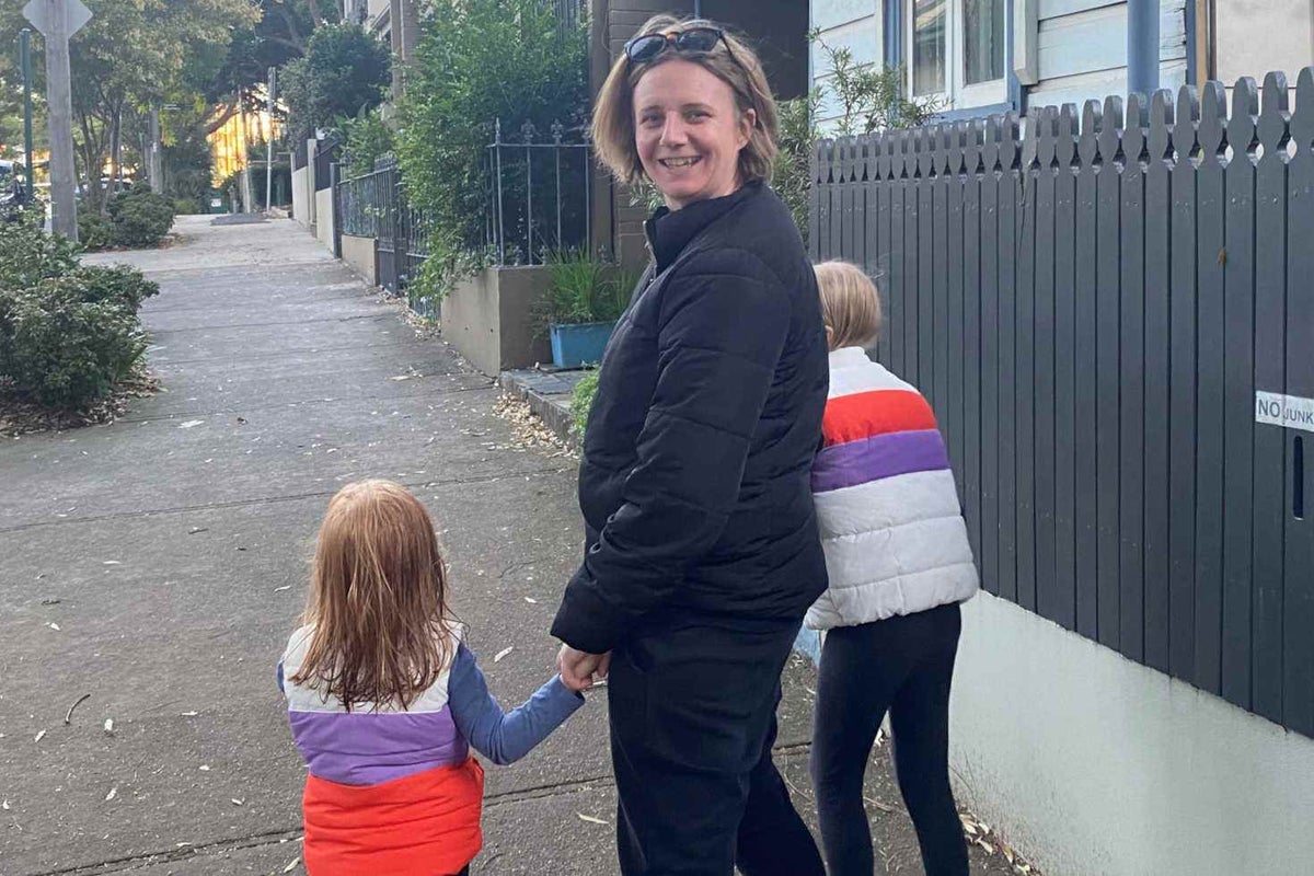 Mother walks with her children.