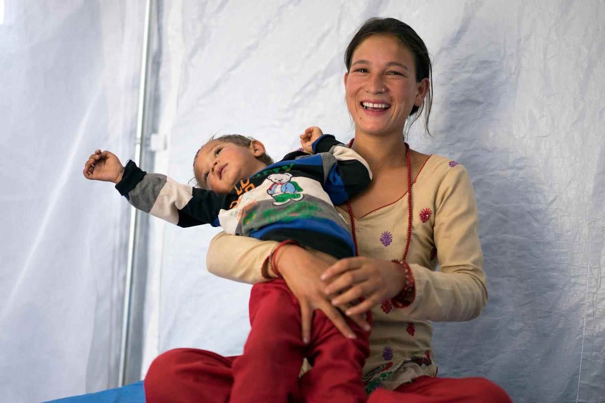 Mother and son in tent hospital.
