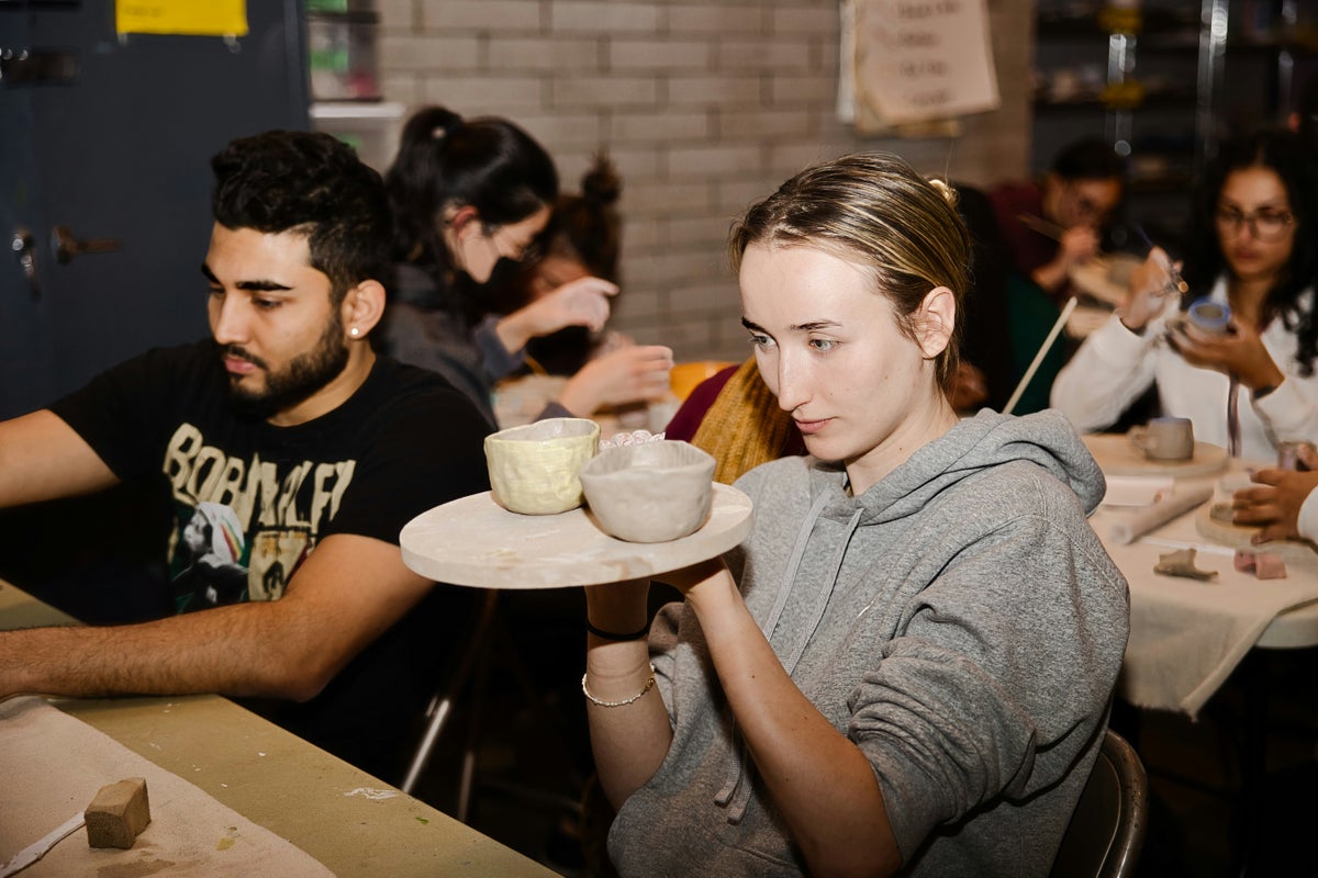 People doing a pottery class as a fundraiser.