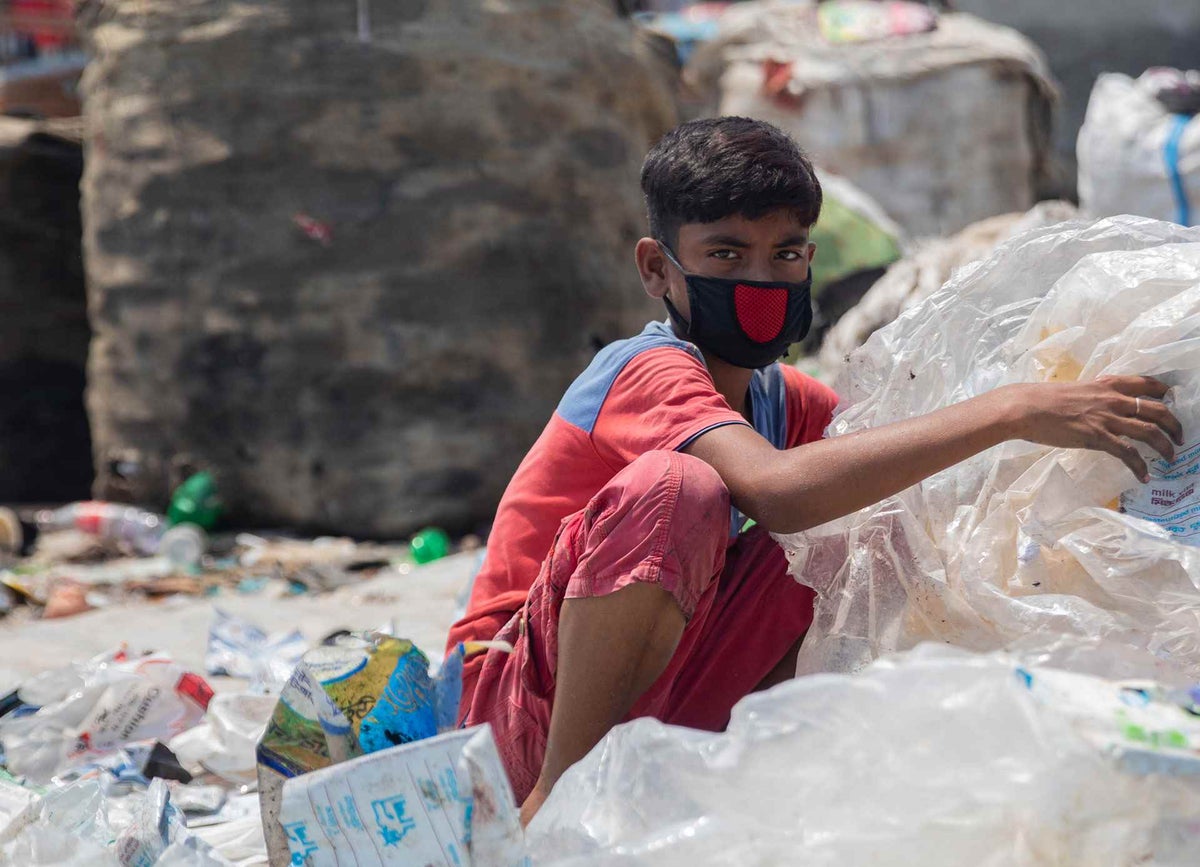 Twelve-year-old Miajul sorts through hazardous plastic waste without any protection, exposing himself to infections and diseases like COVID-19. He has to work to support his family amidst the lockdown