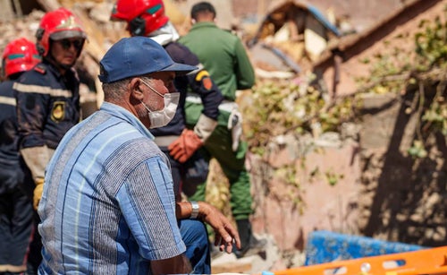 Man sits in the rubble after an earthquake in Morocco