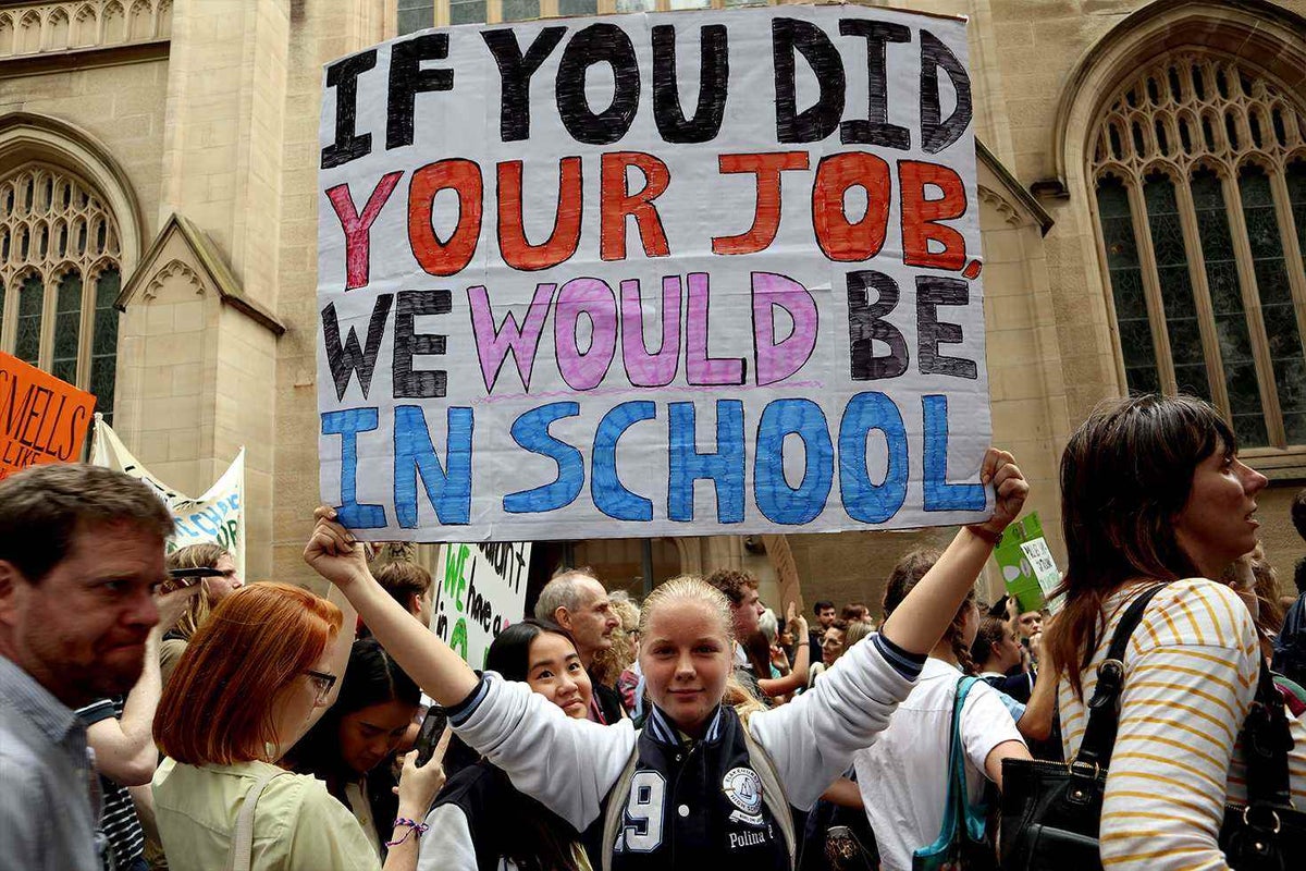 Young female climate change protestor with sign