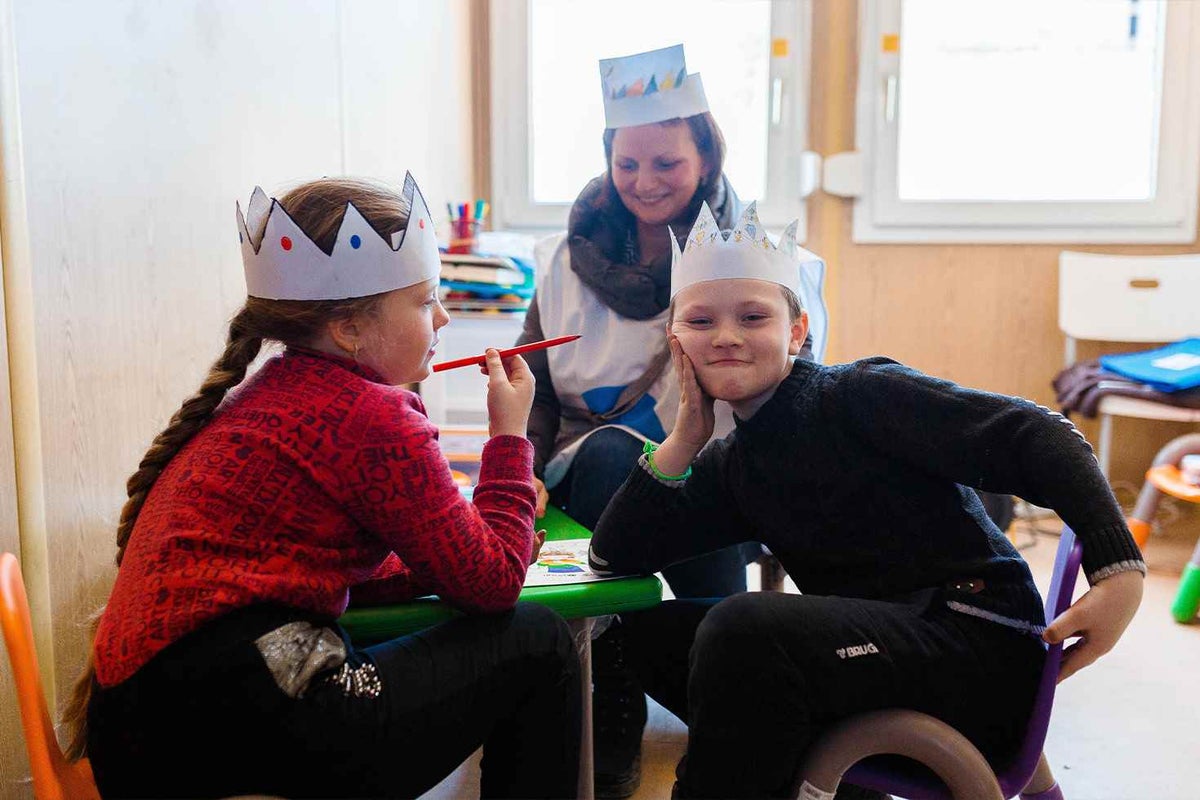 Ivan (right) is happy to be at the Blue Dot child-friendly space at the border crossing in Moldova. In the future, he plans to become an archaeologist.