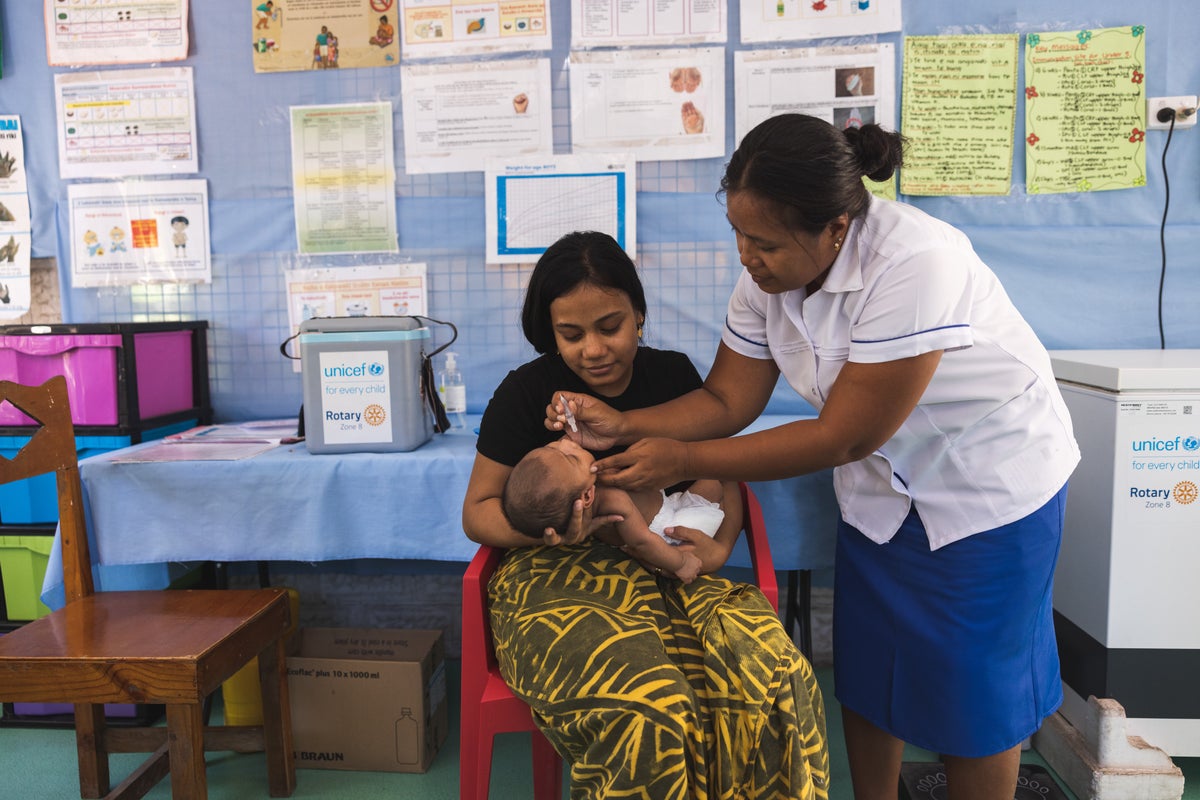 Baby at a hospital in Kiribati receiving life-saving vaccines