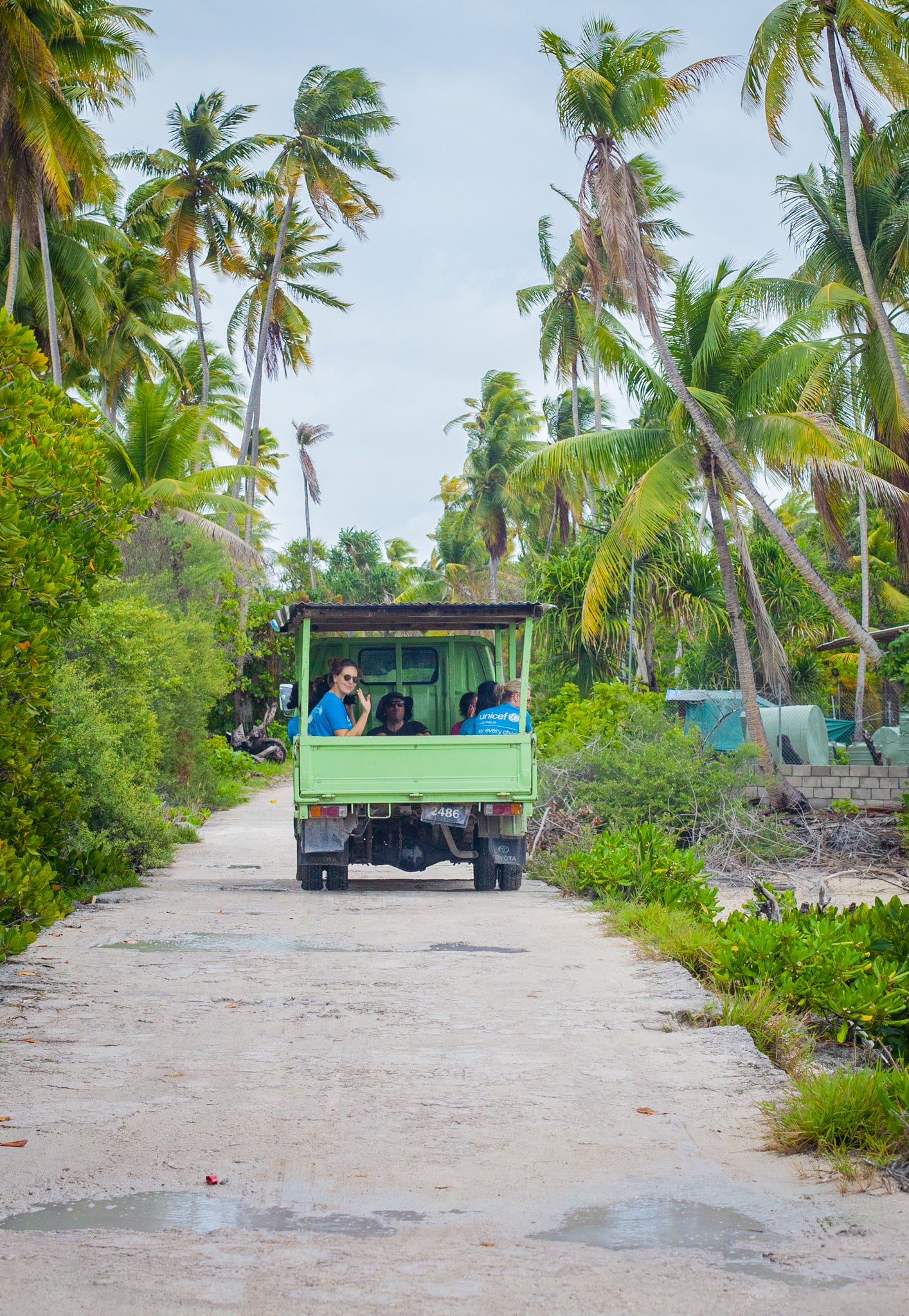 UNICEF staff in a truck travelling through the island nation of Kiribati